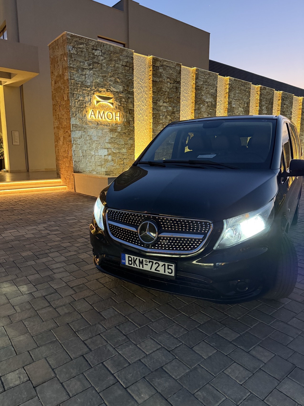 Side view of the black Mercedes van with gold Rhodes Prime lettering on the window