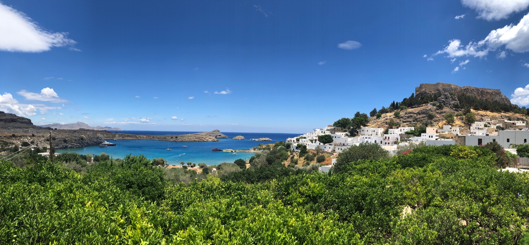 Panorama of Lindos: whitewashed houses, the acropolis and the bay