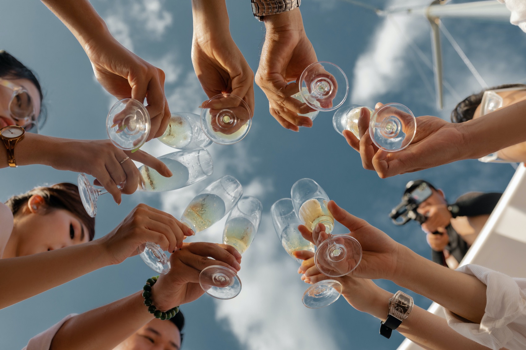 Hands meeting in the middle of a table for a toast