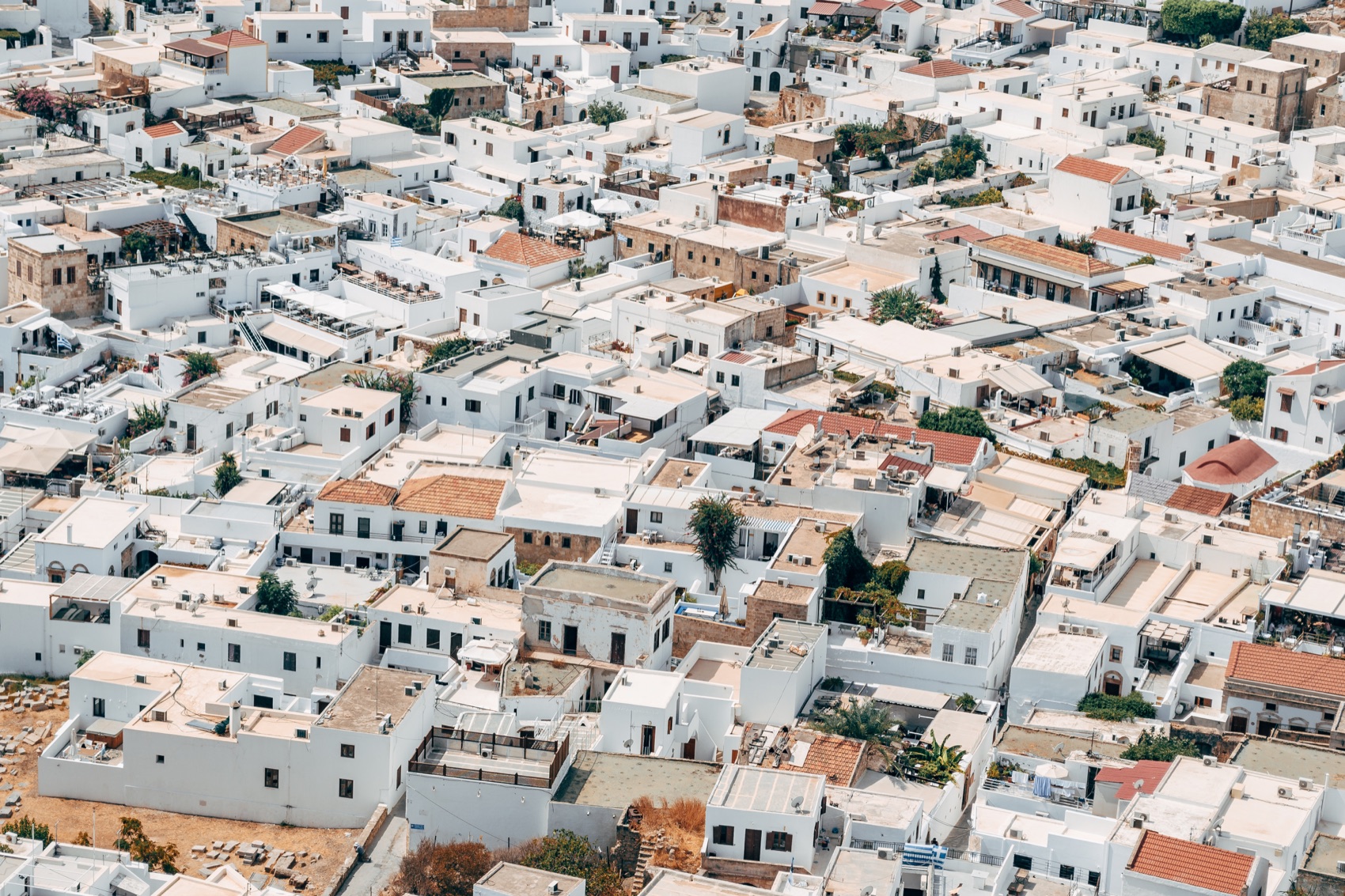 Tiled roofs and whitewashed walls of a village seen from above